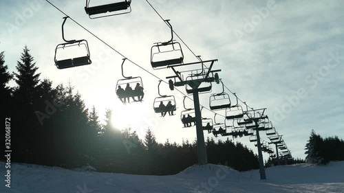 Chairlift with skiers in the mountains
