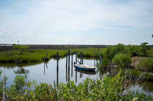 Small boat moored in the wetlands of Tangier Island, Virginia.