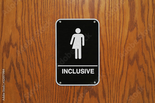 Gender neutral restroom sign that says, INCLUSIVE.