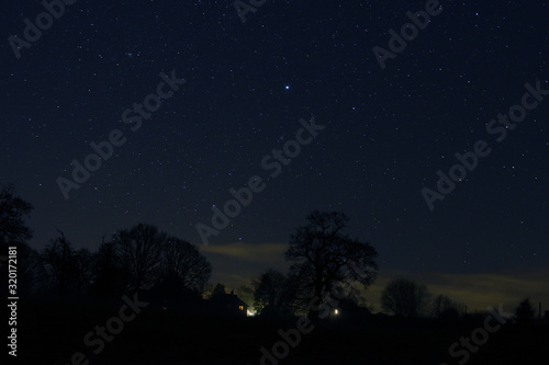 Starry night over small houses in Herefordshire countryside
