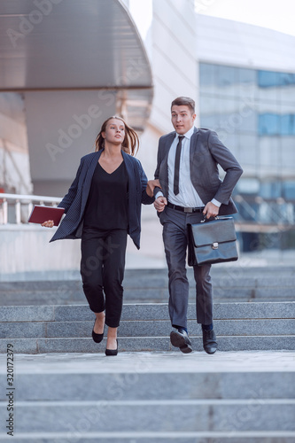 successful business people confidently walking down the city street