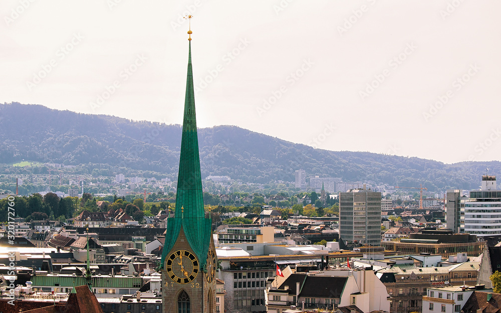 Spire of Grossmunster Church and rooftops of the city center of Zurich, Switzerland.