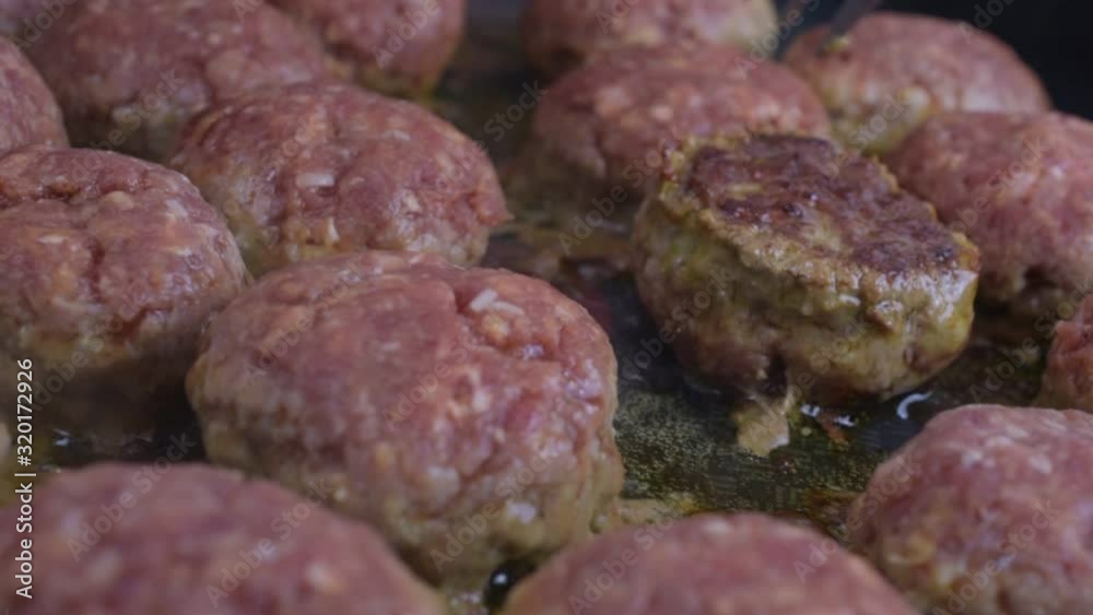 Selective focus. Preparation of delicious home-made meatballs on a pan. Frying raw meatballs in frying pan in hot oil, macro. Seamless video. Selective focus. Preparation of delicious home-made meatballs on a pan. Frying raw meatballs in frying pan in hot oil, macro. Seamless video.