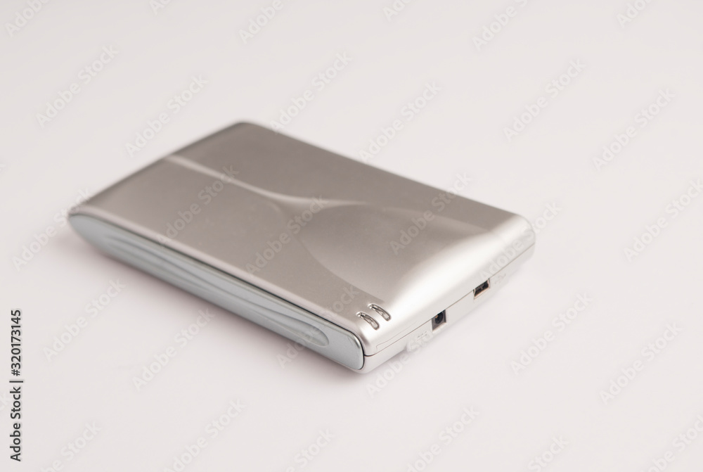Small aluminum gray hard disk, with front loading connections and mini usb connection on white background Small aluminum gray hard disk, with front loading connections and mini usb connection on white background