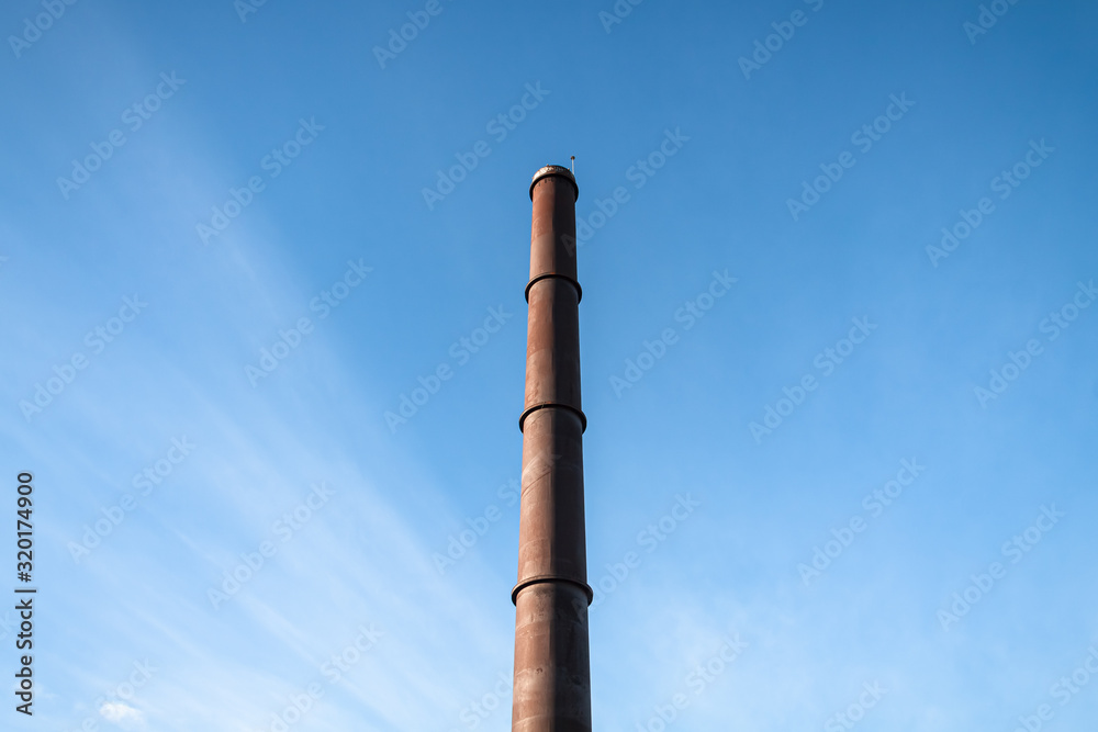 Smokestack with a blue sky in background