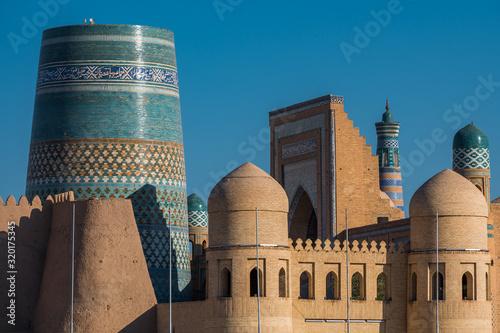 Summer  view of Old City in Khiva, Uzbekistan with unfinished Kalta Minor Minaret with arabic text 
