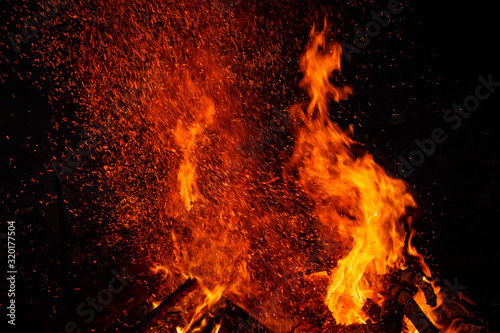 Big bonfire with sparks flying up  colorful space effect