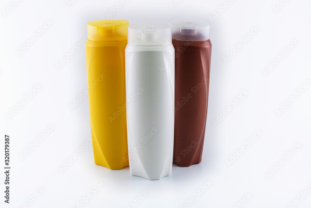 Shampoo bottles photographed on white background. Photographed in a studio setting. Shampoo bottles photographed on white background. Photographed in a studio setting.