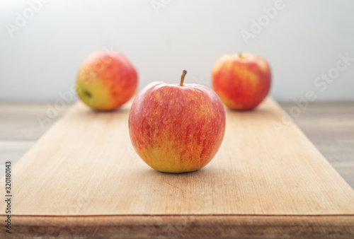 red juicy apple on wooden table