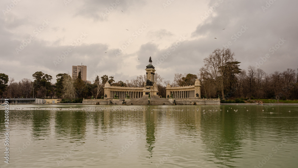 Beautiful view of the monument of Alfonso XII in the Retiro Park on a cloudy winter day in Madrid. Travel concept.