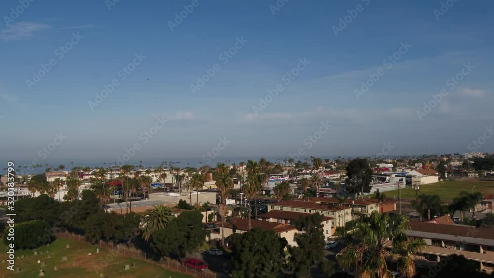 Aerial dolly in sunny city shot with beach in background in California Aerial dolly in sunny city shot with beach in background in California