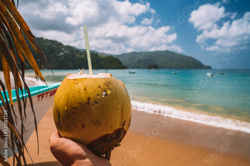 Photography Coconut drink on sand beach, summer vacation on beach on the remote island in the middle of the ocean