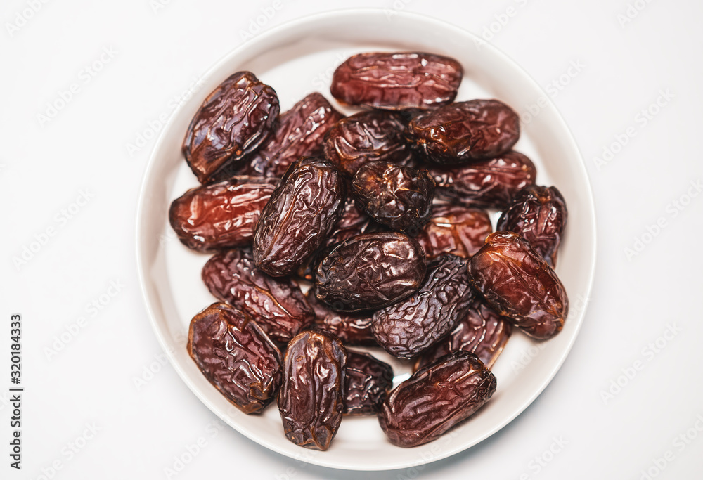 Fresh Medjool Dates on a white plate Fresh Medjool Dates on a white plate