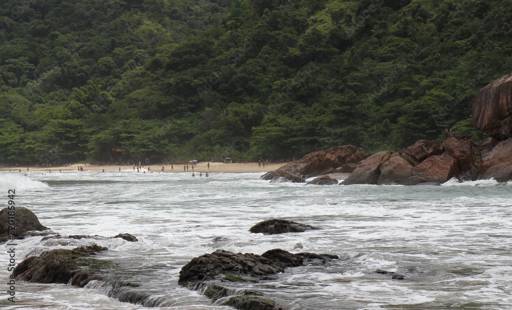 Trindade, Paraty/Rio de Janeiro/Brazil - 01-19-2020: Praia do Meio beach. Strong waves, dangerous sea, drowning risk, sorrounded by many rocks