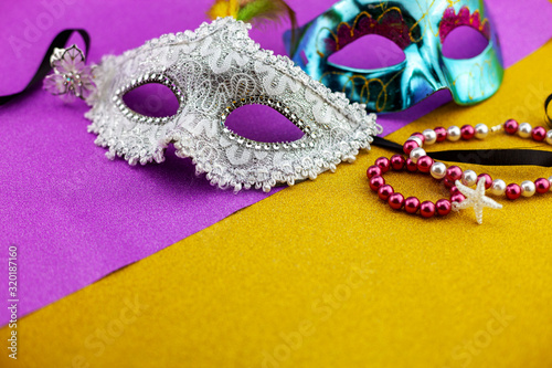 A festive,Beautiful white mardi gras or carnival mask on beautiful gold paper background.
