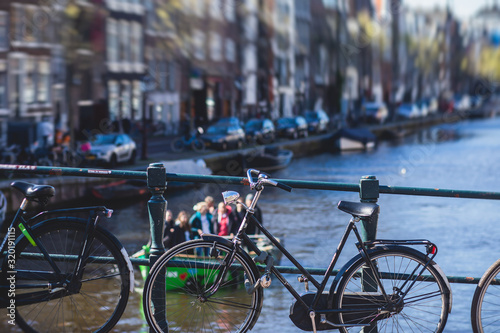 View of Amsterdam street in the historical center, with canal houses in the capital city of Amsterdam, North Holland, Netherlands, summer sunny day photo