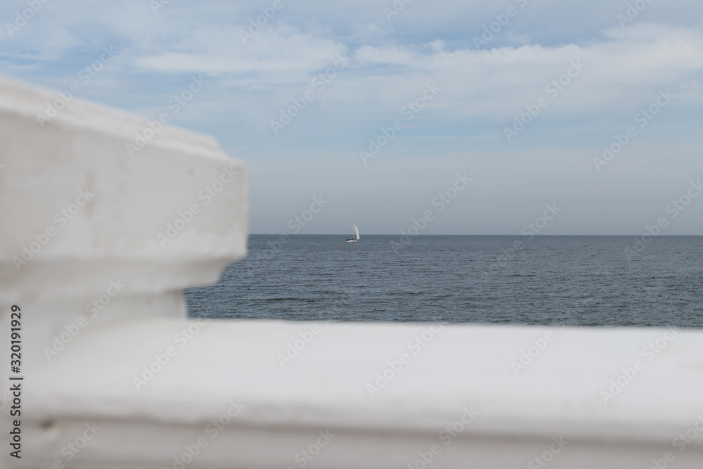 Fototapeta premium white sail alone in the mist of the blue sky that he is looking for the edge of the far