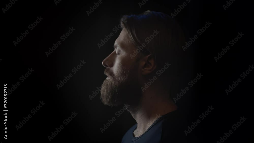 Bearded man slowly rise his head, slow motion Bearded man slowly rise his head, slow motion