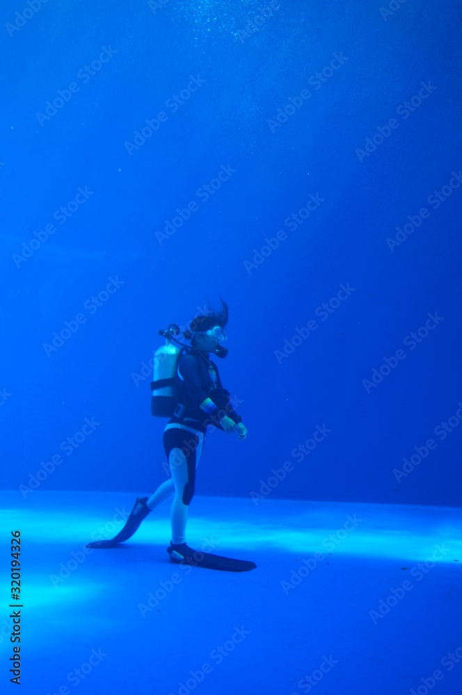 Diver swimming in blue underwater