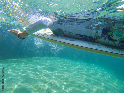 Photo of a girl on a surfboard from under the water © nelasova