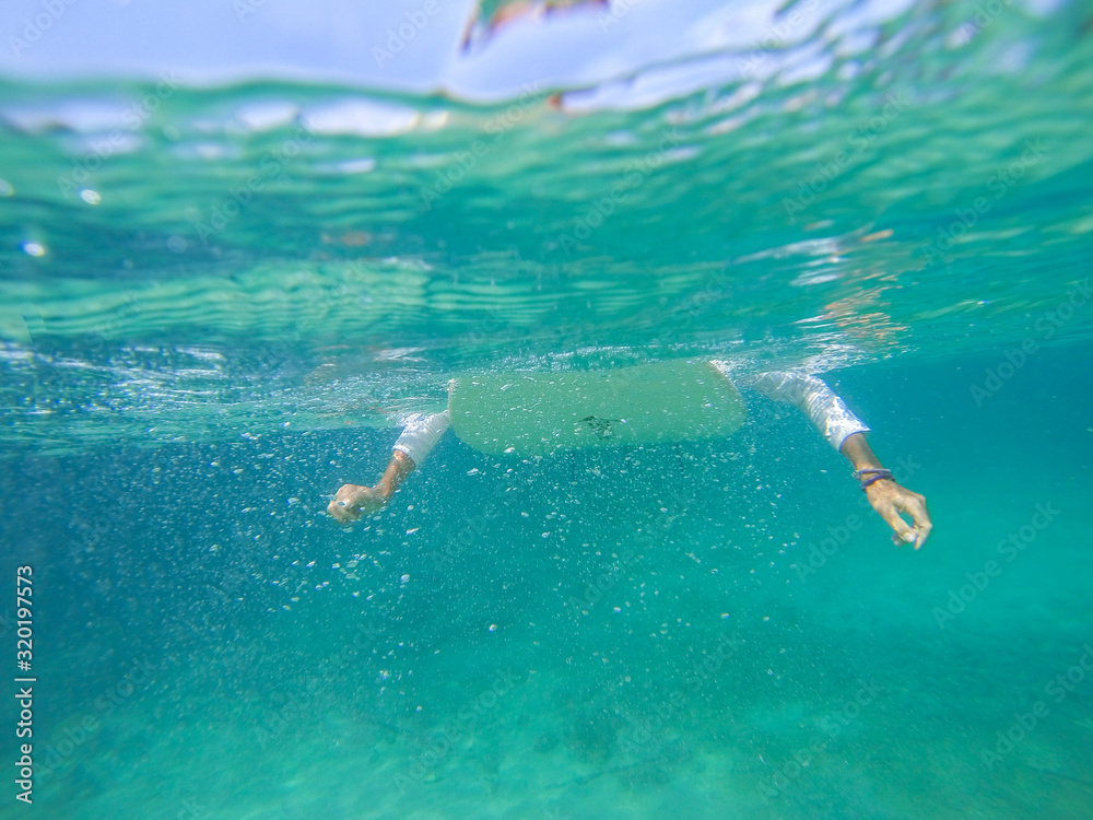 Surfing on the ocean wave photo underwater