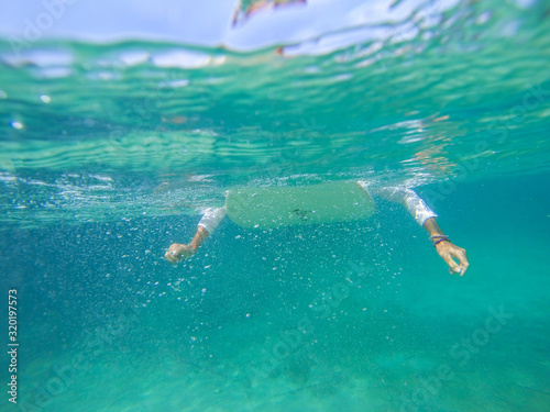 Surfing on the ocean wave photo underwater
