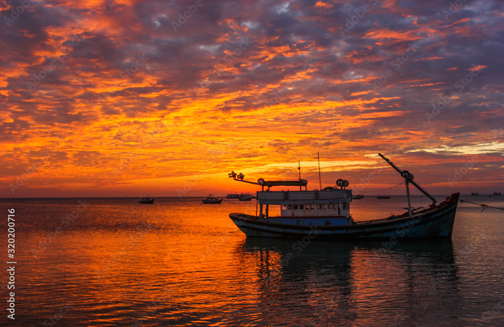 Fishing boats against the background of a purple sunset