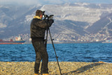 Video operator on a winter beach