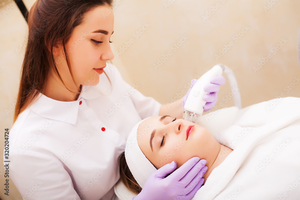 Woman getting LPG hardware massage at the beauty clinic Woman getting LPG hardware massage at the beauty clinic