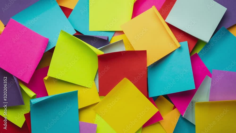 Colorful blank sticky notes being dropped onto canvas board - stop motion animation, business reminder concept