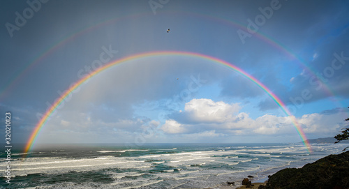 Beautiful double rainbow over the ocean off the oregon coast photo