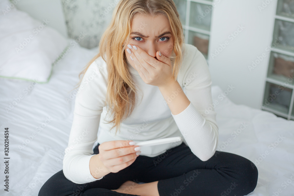 Worried sad woman Looking at a Pregnancy Test after result. Worried sad woman Looking at a Pregnancy Test after result.