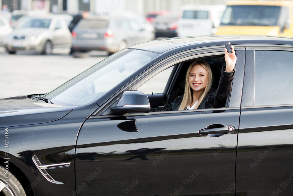 Young happy woman bought new modern car.