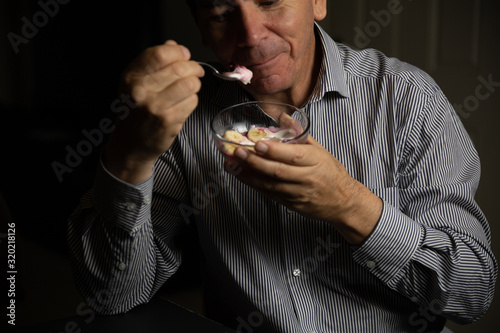 Man with healthy life having healthy breakfast with fruits, yogurt and cereals with fruit juices photo