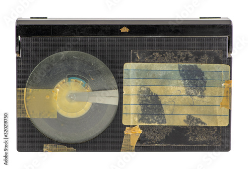 Old betamax video cassette isolated on white background. Vintage video technology. Blank, weathered sticker.
