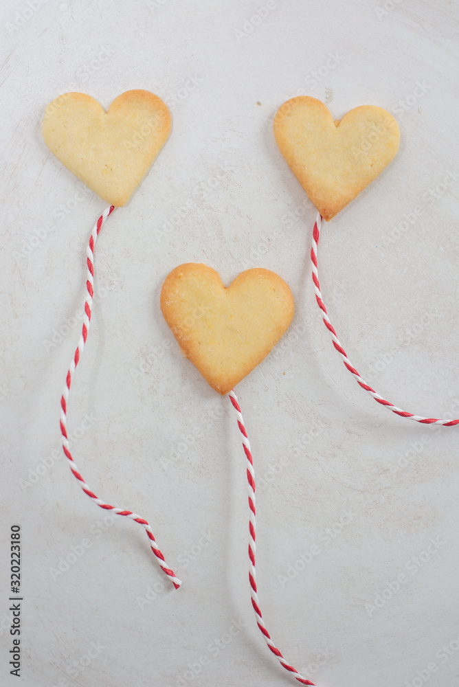 Valentines Day Concept: closeup of fresh baked heart shaped cookies on a table