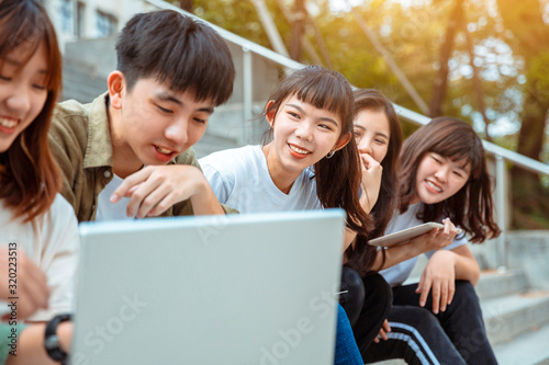 Group of students studying on the stairs  at campus
