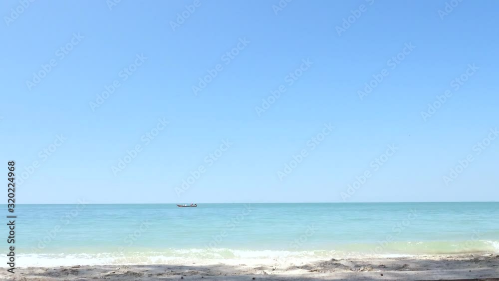 Trat Beach Sea Sand Thailand. Landscapes view of nature beautiful beach,Clear turquoise tropical sea and powder beach of Southeast Asia with slow moving fishing boat in the far horizon. Trat Beach Sea Sand Thailand. Landscapes view of nature beautiful beach,Clear turquoise tropical sea and powder beach of Southeast Asia with slow moving fishing boat in the far horizon.