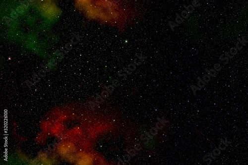 Outer space with colored nebulae and stars.
