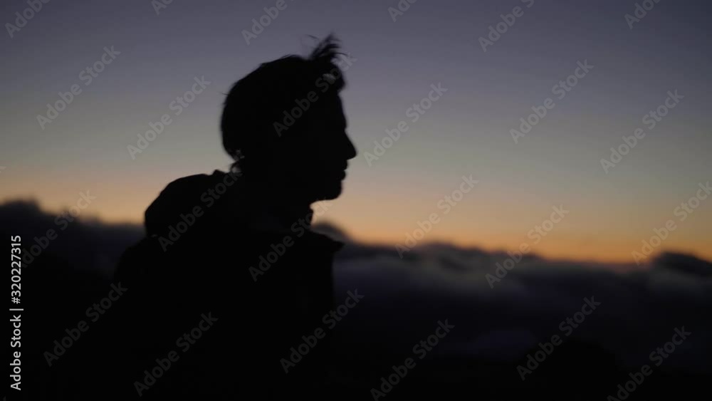 Madeira Island, Portugal - Silhouette Of A Man Walking Alone Outside On A Cool Windy Sunset - Closeup Shot Madeira Island, Portugal - Silhouette Of A Man Walking Alone Outside On A Cool Windy Sunset - Closeup Shot