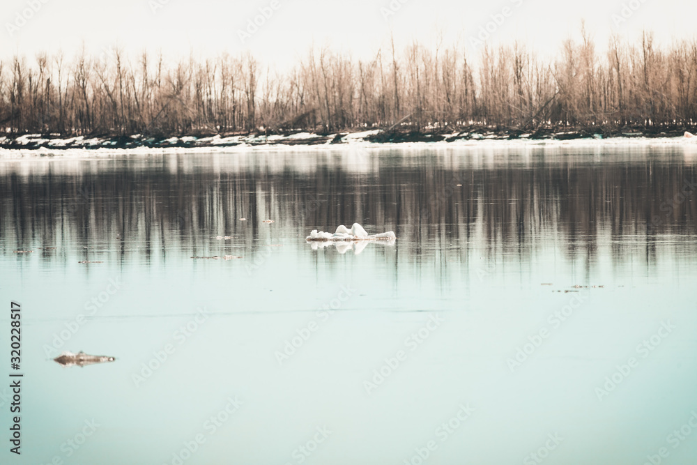 Early spring drift on beautiful river with broken off pieces of ice float down the stream. Early spring drift on beautiful river with broken off pieces of ice float down the stream.