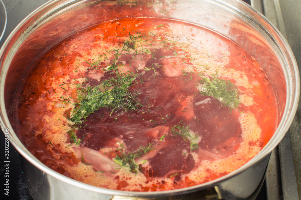 Red soup borscht cooked in large pan on stove. Red soup borscht cooked in large pan on stove.
