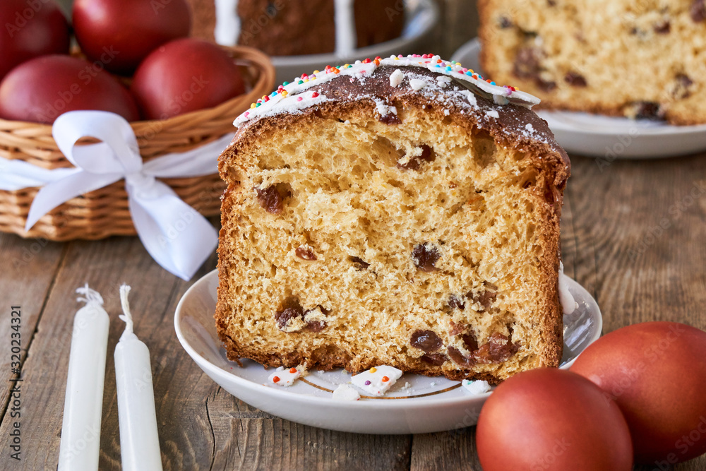 Piece of easter cake with brown colored eggs on a wooden table Piece of easter cake with brown colored eggs on a wooden table