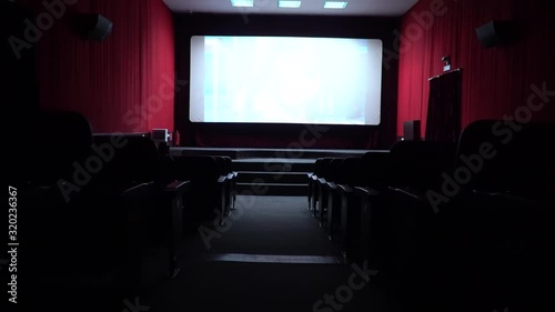 Empty movie theater, watching a movie. cinema hall. Viewers watch a movie in a movie theater. Filmmakers watch the film on an empty screen