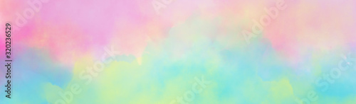 Colorful watercolor background of abstract sunset sky with puffy clouds in bright rainbow colors of pink green blue yellow and purple