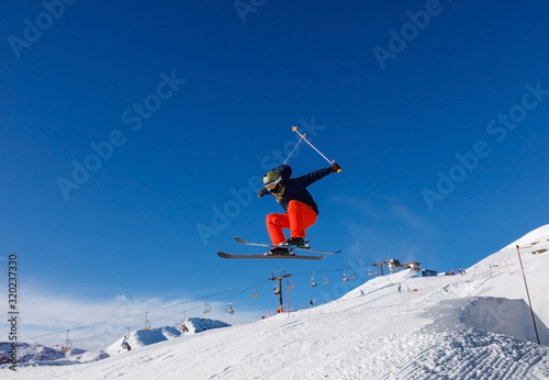 Skier caught big air in snow park in Livigno ski resort, Italy photo