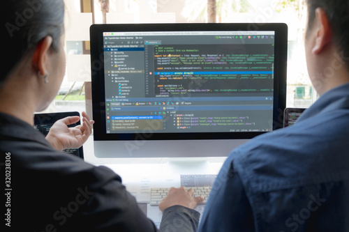 Programmers work on the development of coding and coding technology on white desks and website design, software, data processing companies, servers.