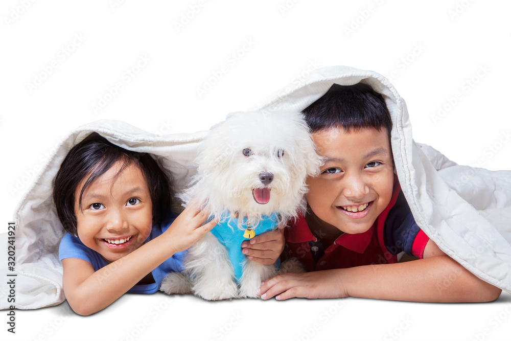 Kids smiling at cam with their dog under blanket Kids smiling at cam with their dog under blanket