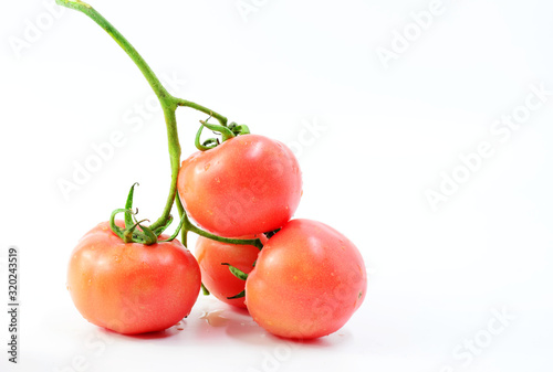 A bunch of little red tomatoes on a white background