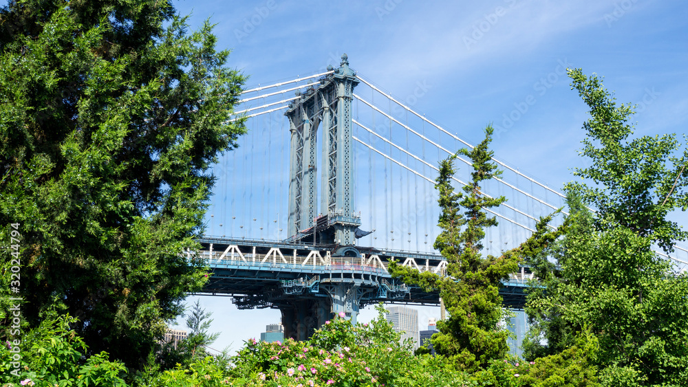 Obraz premium New York, NY, USA. Views of the Manhattan bridge from the historic and trendy Dumbo neighborhood. Wonderful summer day. Holiday time